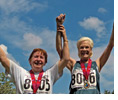 Senior Citizen man and woman athletes with raised arms